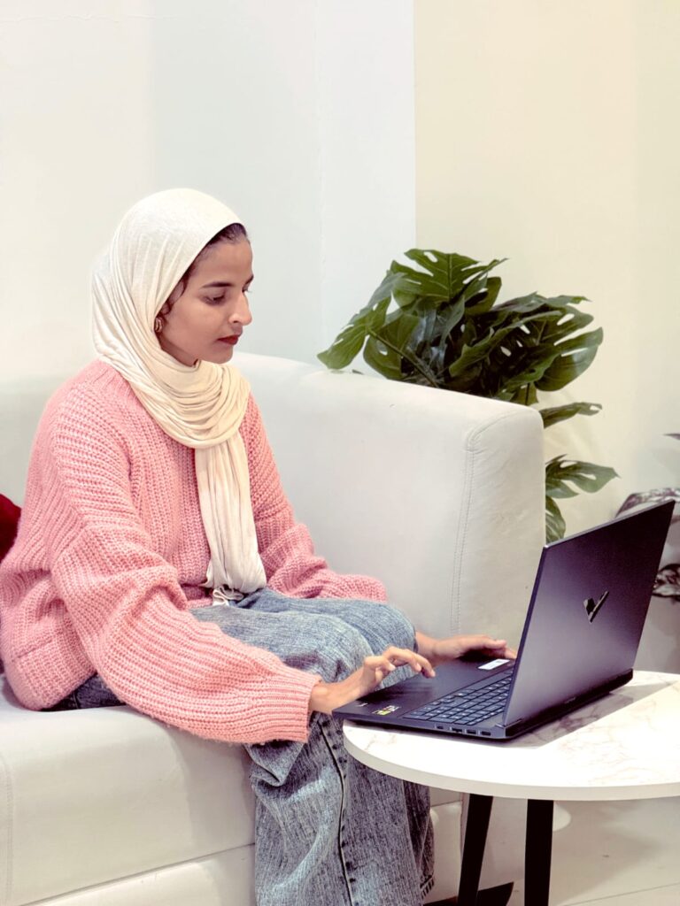 Best Digital Marketing Specialist iIn Palakkad, Kerala. Shajla standing confidently in a green themed background representing professional branding and digital marketing expertise